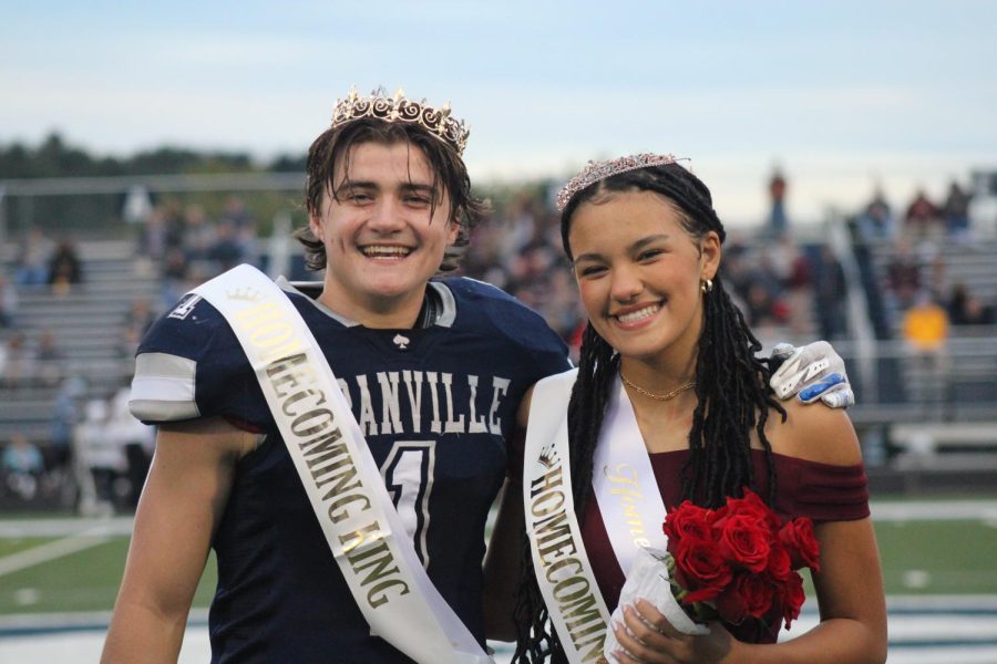 Senior Mike Chaykowski smiles with Senior Bella Jhordan after being crowned Homecoming King and Queen before the game.