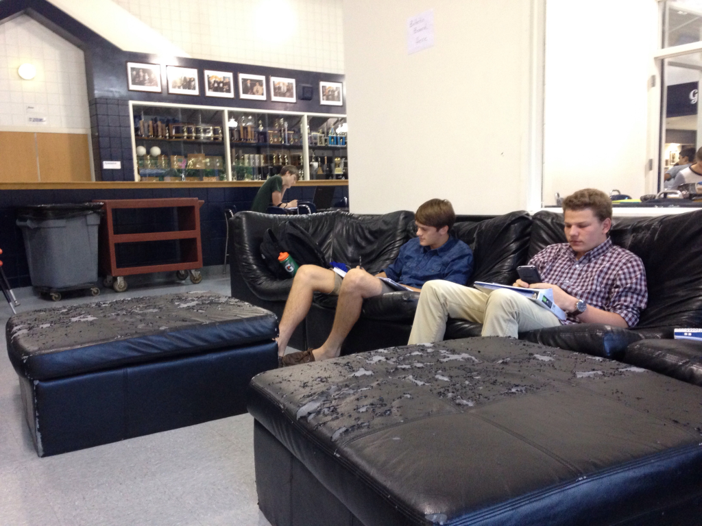 Seniors Jake Dorman and Barrett Williams work on homework on the tattered couches in the Senior Lounge. PHOTO BY MADELINE WALKER