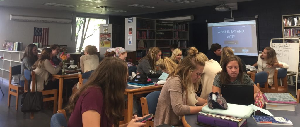 Photo by Kylee McFarland. Seniors learning about college in the schools library. 