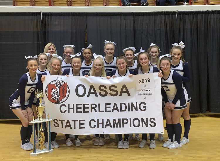 The Blue Aces competition cheer team holds up championship banner after winning the OASSA state title (Photo Courtesy of Granville Cheer Twitter).