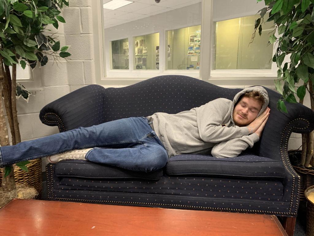 Senior Sam Klaus takes a quick nap break to rejuvenate after a long night of doing homework. (Photo by Lauren Kiernan). 