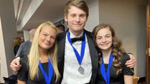 Choir students Lanie Schott, Matthew Steele and Lillian Reese smile after performing at the OMEA All-State conference. They received medals for their handwork and dedication. Photo courtesy of Kristen Snyder.
