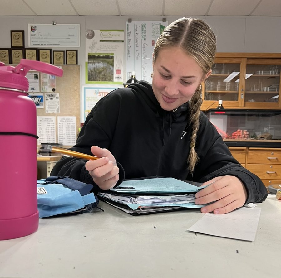 Senior, Ava Miller, looks at her notes in order to study.