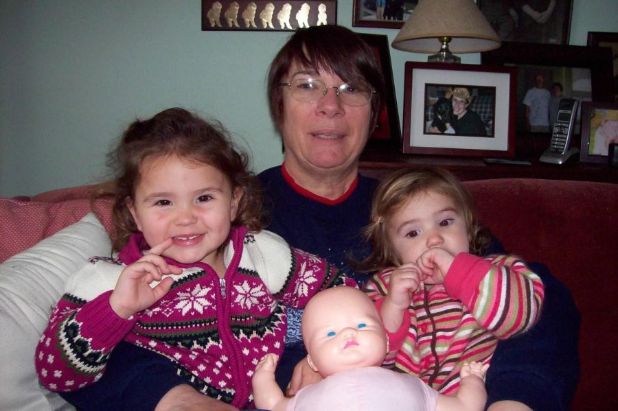 Me and my sister sitting with our grandma around Christmas time in 2009.