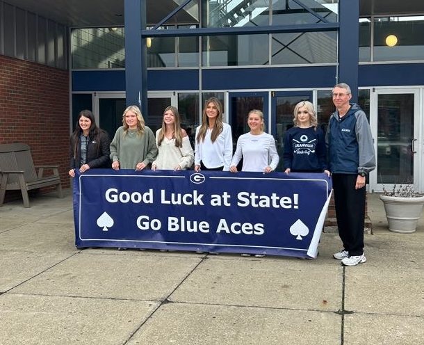 Ainsley Laidlaw-Smith, Hannah Huggins, Lydia Wigal, Avery Stanton and Olivia Page-Jones pose with their coaches prior to the State tournament. They were the first girls golf team to qualify for State in school history.