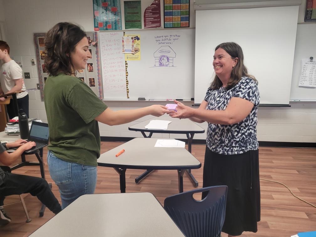 Senior Teresa Collins presents English teacher Beth Simmons with a gift of appreciation from Key Club.