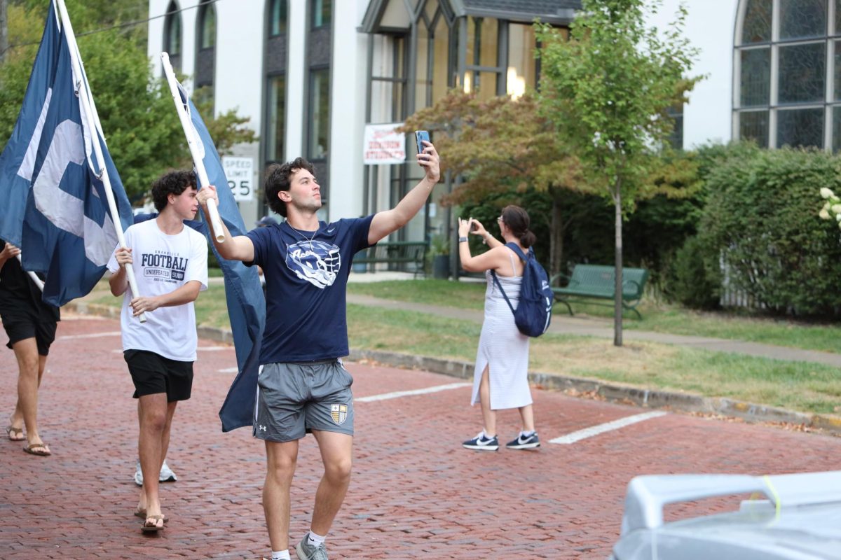 Matthew Rosen snaps a selfie while walking in the Homecoming parade.