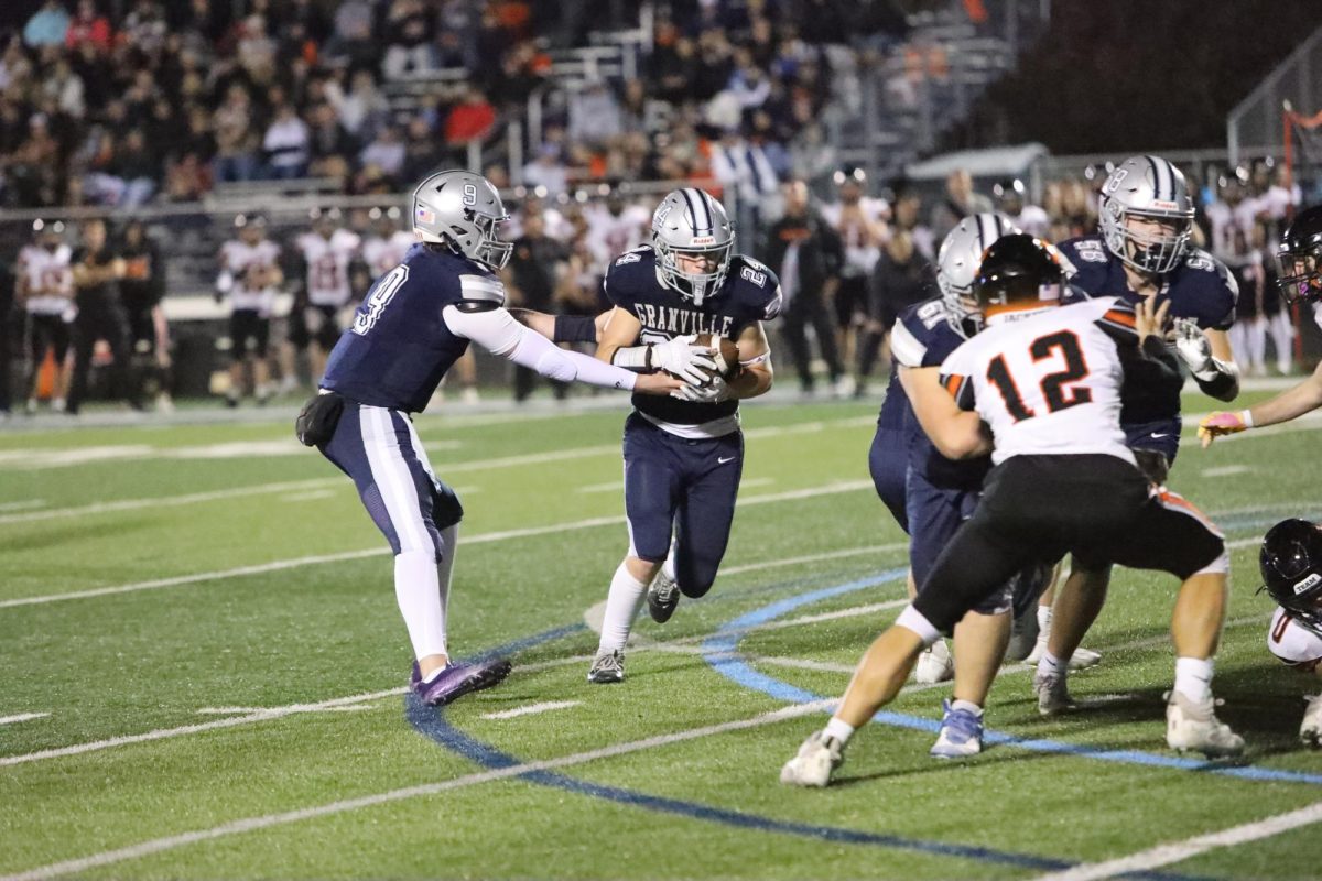 Quarterback Jackson McMillin hands off the ball to Luke Bosse.