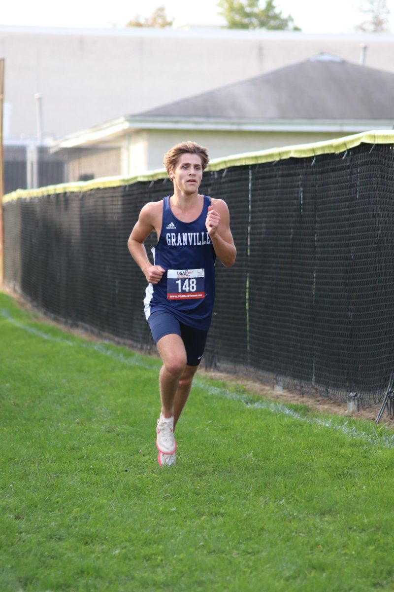 Eyes on the prize. Cohen Stump (12) runs ahead of the competition, approaching the finish line. Cohen placed 1st at the LCL Meet on Oct. 12. Stump says that he likes to listen Bruno Mars and take naps on the bus before every meet.