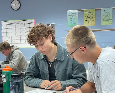 John Whiting and Rory Karon-Lackey work on a project for their CCP Composition and Rhetoric class. 