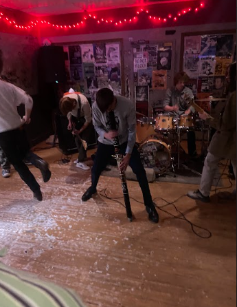 OCRAM members Owen Costa, Sam Hannig, Liam Dunkes,and Nolan Gay at their recent show at the Dirty Dungarees Laundromat in Columbus. Mid-song, front man Owen Costa broke out a didgeridoo to add a theatrical flare to the song. Photo courtesy of Addie Hannig