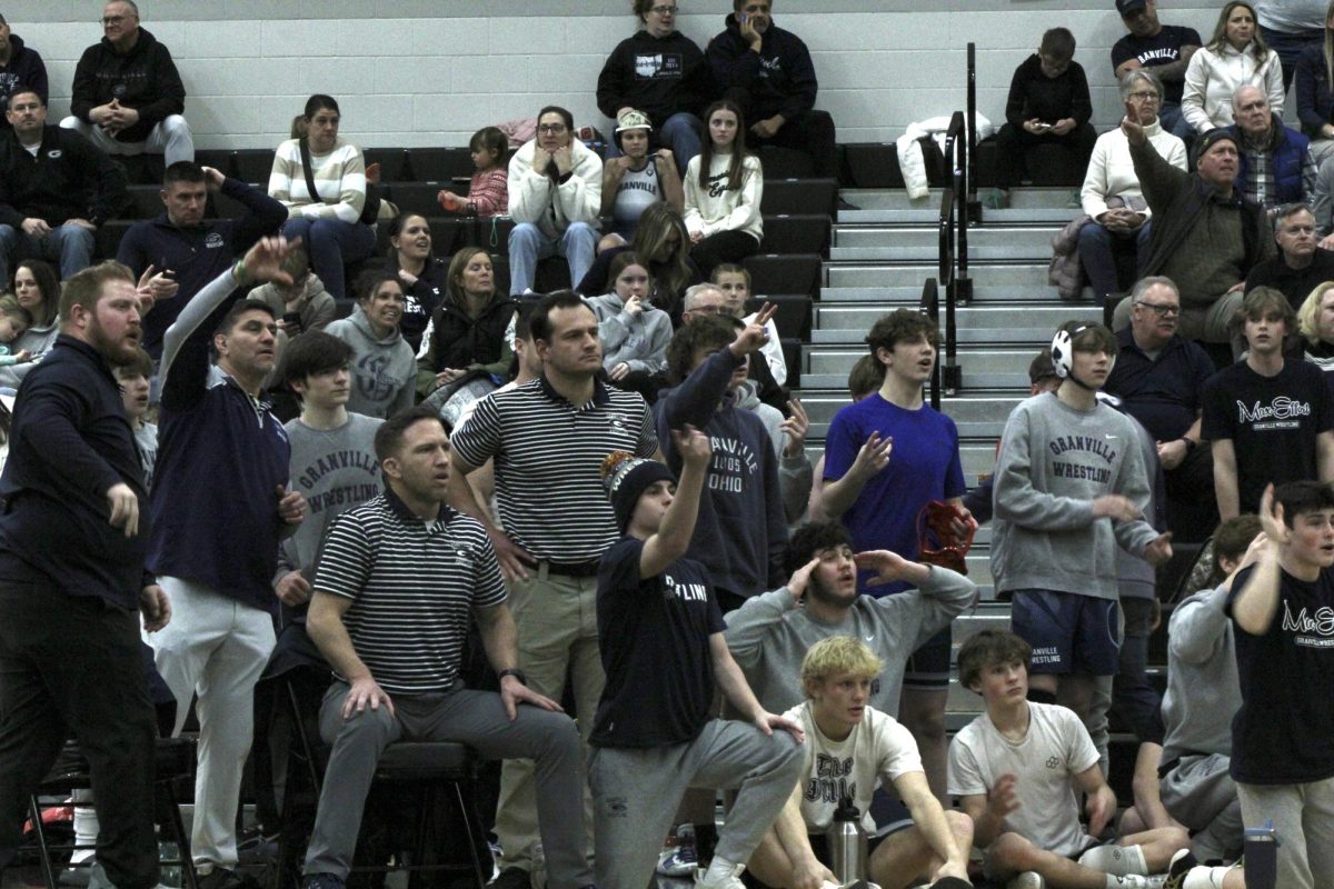 Teammates and coaches are perplexed by the referee's call. 