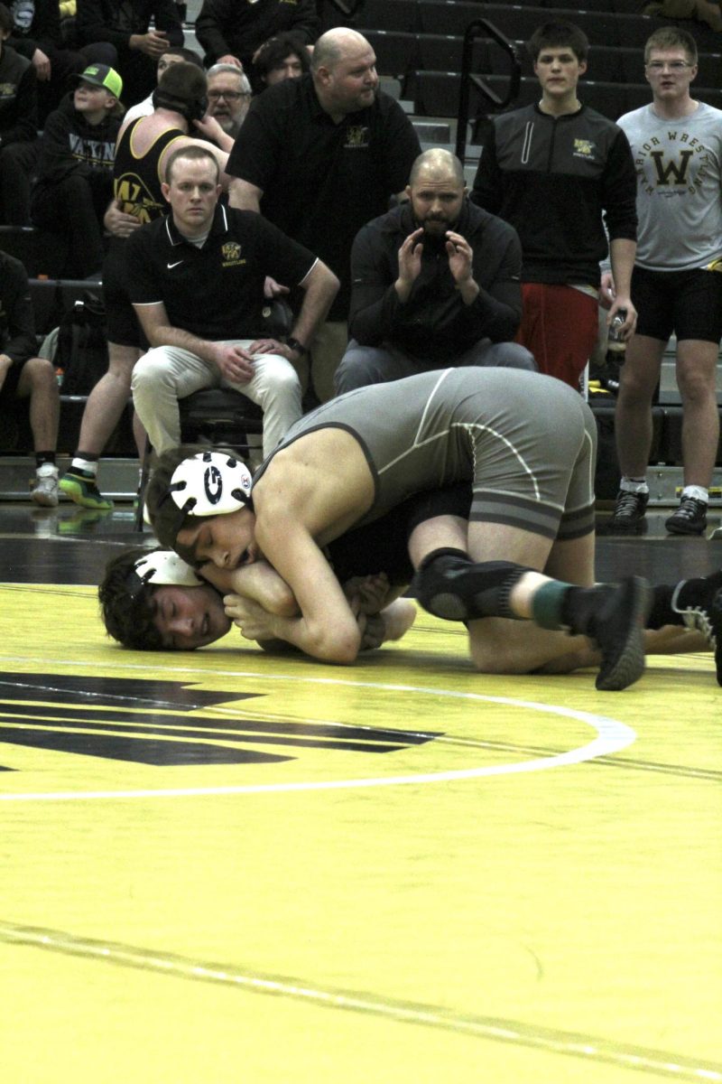 Blank Blank blank tries to wrestle his opponent to his back. 