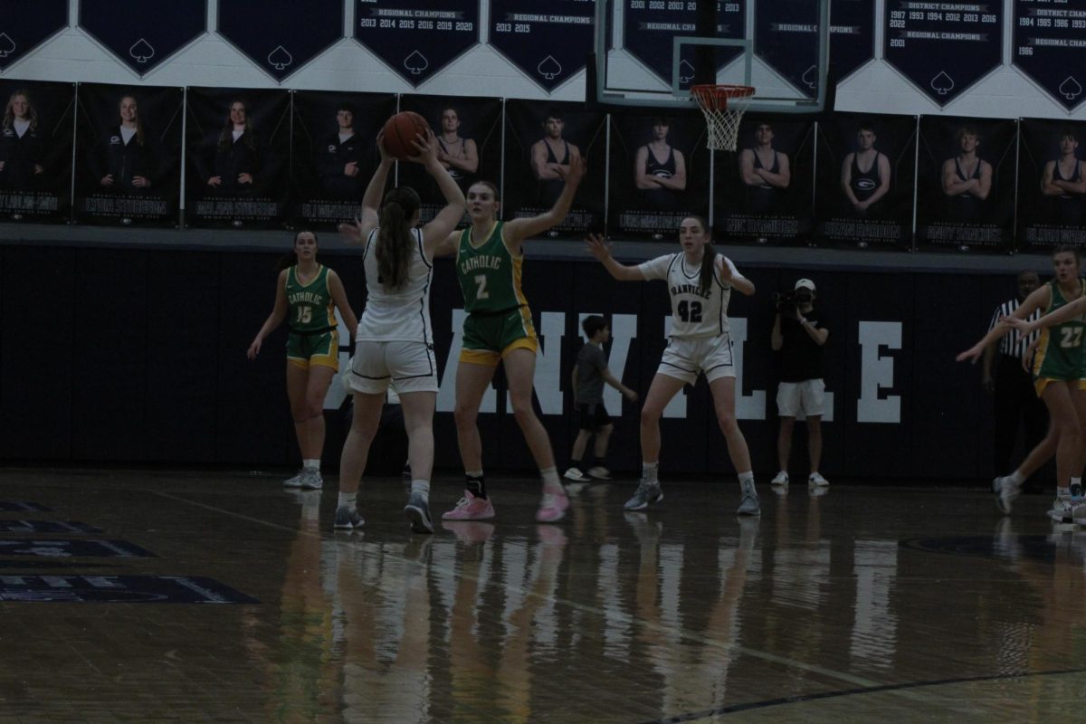 Senior Katie Cottrell gets ready to pass the ball the sophomore Elle Mortimer.