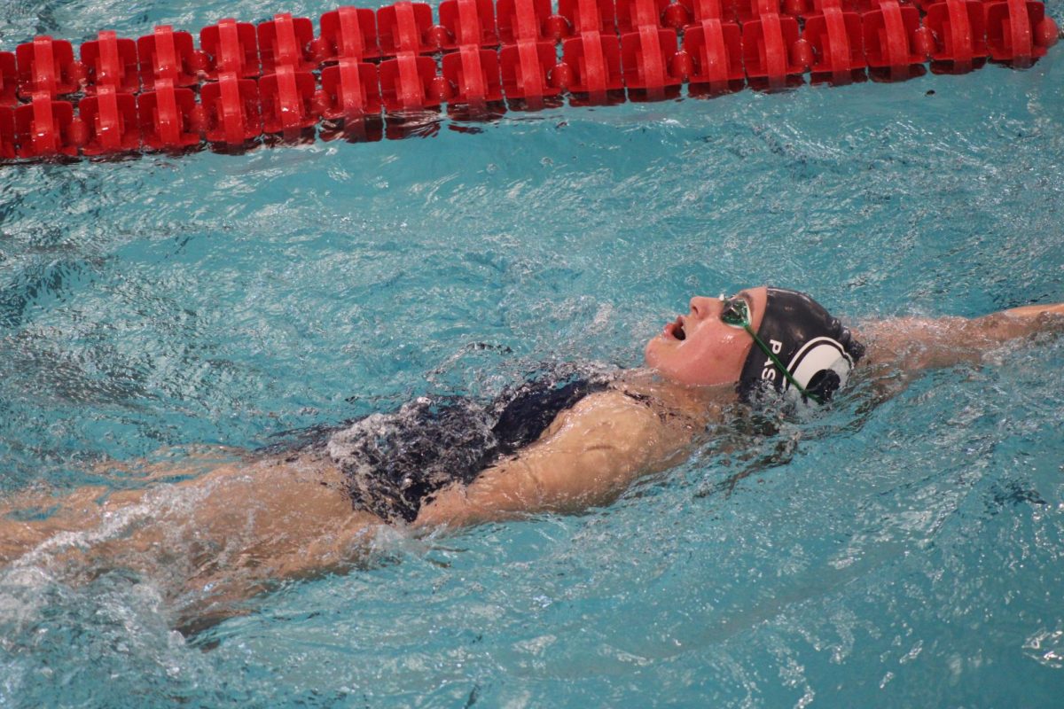 Julie Pastiva (9) competes her backstroke. Granville sets new records, brings home new trophies, and swimmers Lydia Sturgeon and Nolan Schneider are crowned LCL swimmers of the year. 