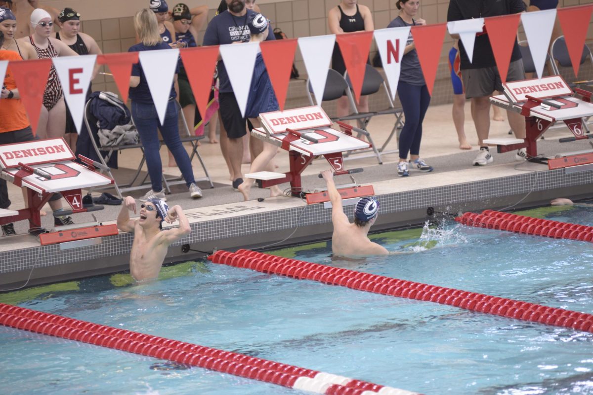 Sophomore Oliver Rodgers flexes at the crowd after finishing his heat during the meet.