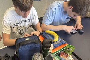 Sophomores Ben Rose and Seth Winterhalter use their phones during lunch