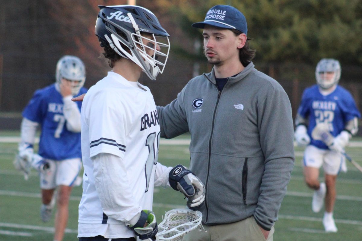 Varsity head coach Paul Kirk consults one of his players during their game against Bexely.