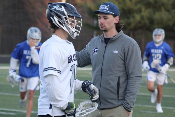 Varsity head coach Paul Kirk consults one of his players during their game against Bexely.