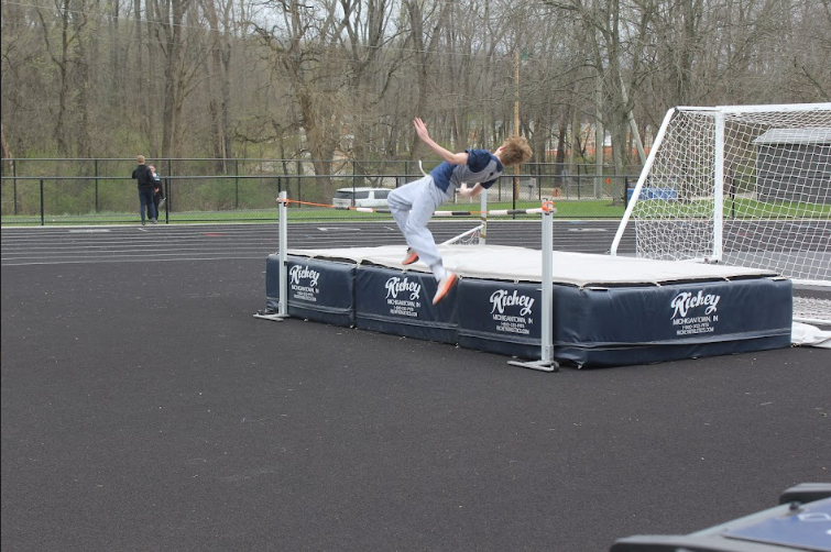 Sophomore Luke Mahl in the middle of high jumping. 