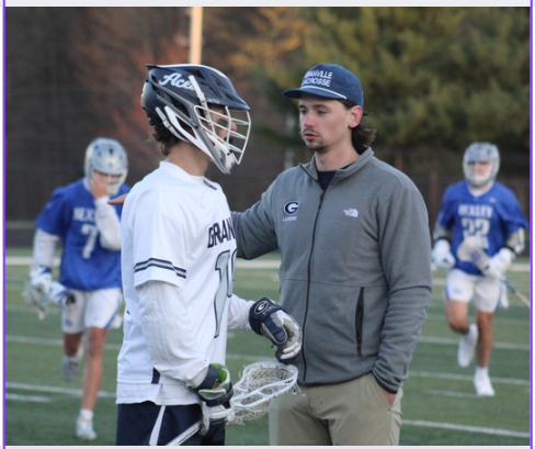 Varsity head coach Paul Kirk consults one of his players during their game against Bexely