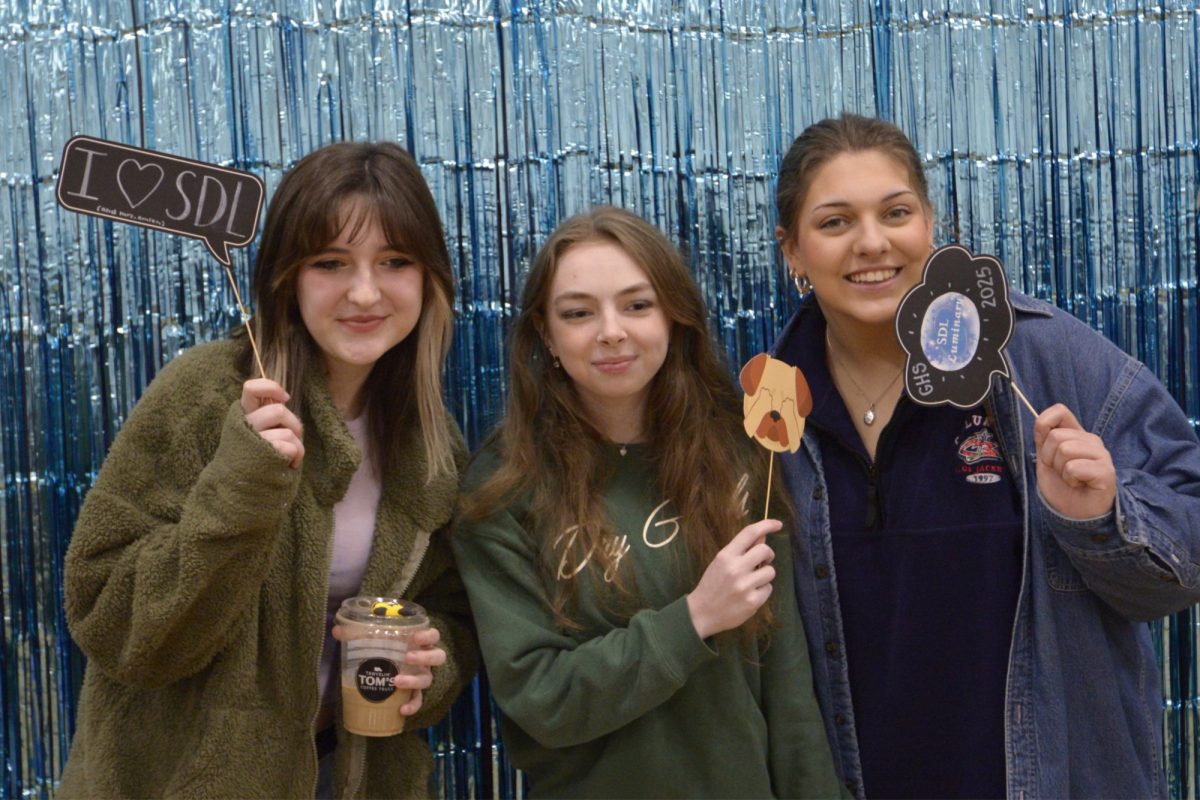 Avery Boone, Maddie Baumbach and Reagan Moore pose in the photo booth during the SDLuminary event on April 6.