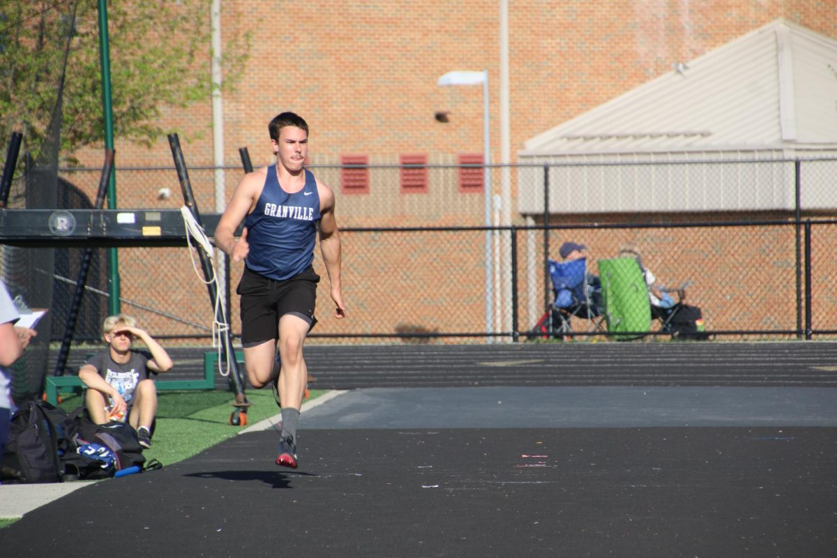 Cade Roberts (11)  fuels up to jump in the high jump event 