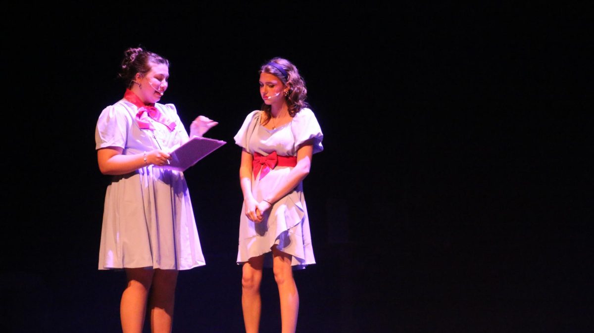 Fairy Godmother, played by Sophia Shinka (12), ignores her daughter Jane, Ava Whitmeyer (11), when she tries to tell her about the mischief the Evils have been up to. 