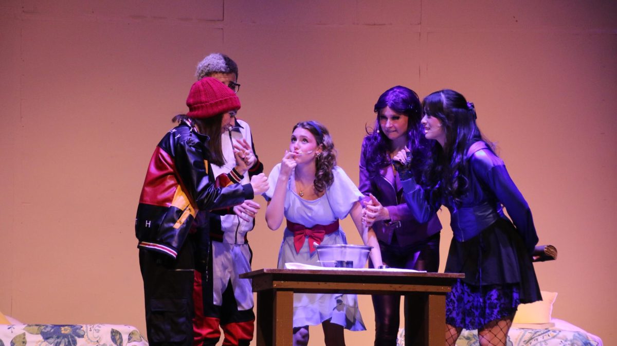 Ava Whitmeyer (11) tests the Evil's cookie dough as Max Holtsberry (11), Andrew Busack (10), Chloe Thatcher (12), and Miho Gillespie (12) worry that she's been spelled. 