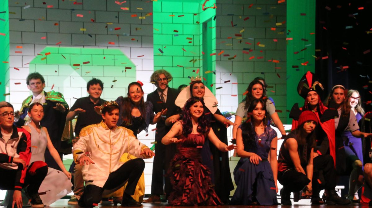 The cast poses as a burst of confetti marks the end of the show. 