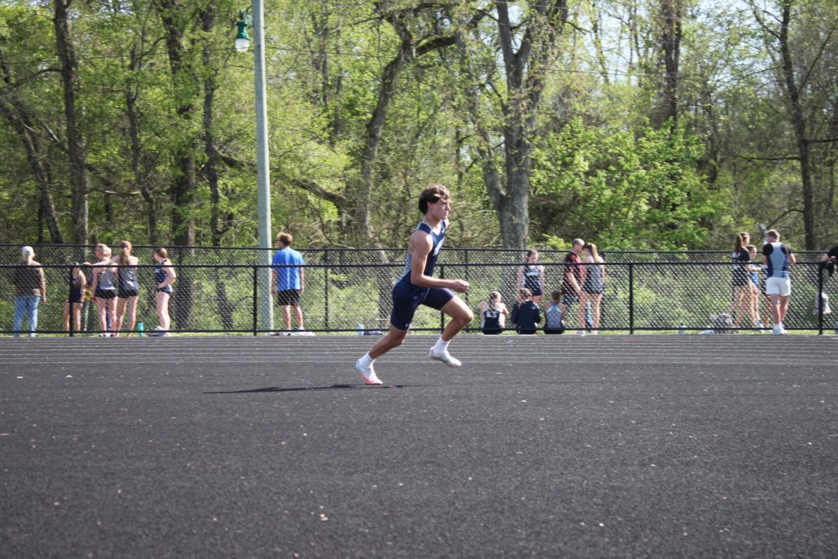 Freshman Parker Costa runs up to high jump. 