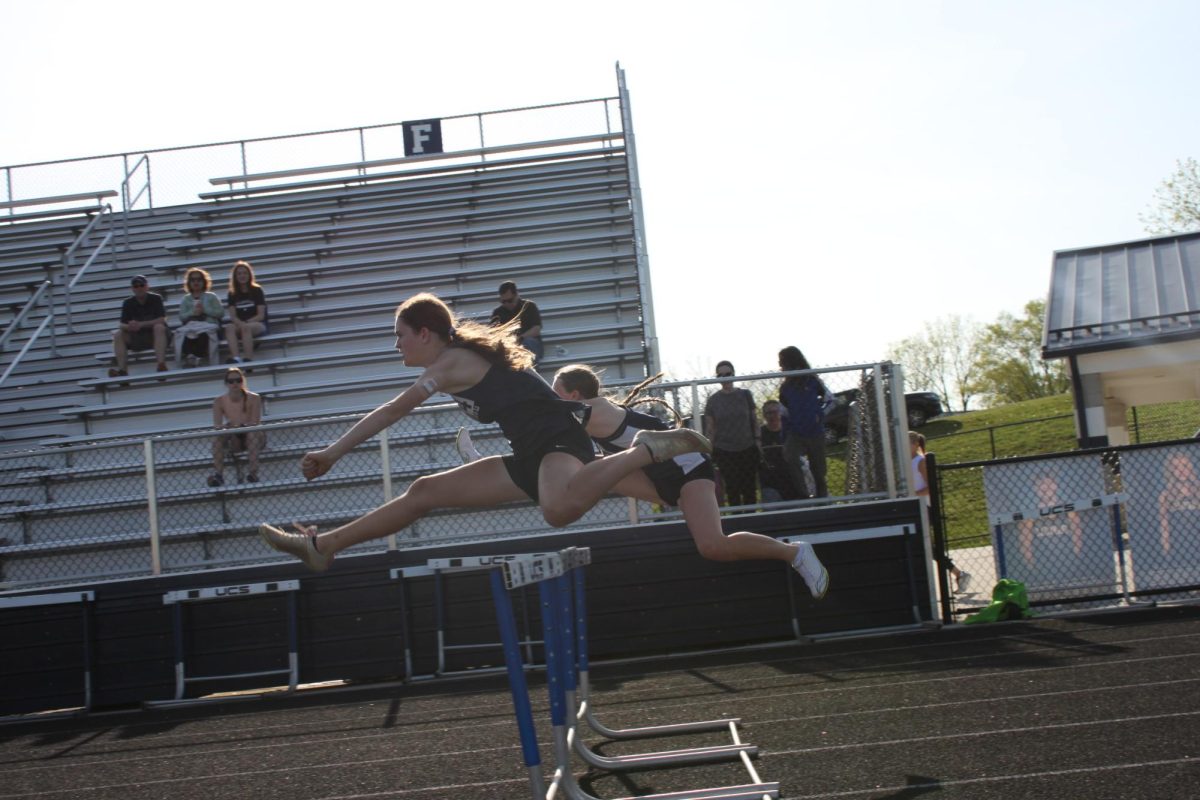 Freshman Sophia Price hurdles in the 100m hurdles.