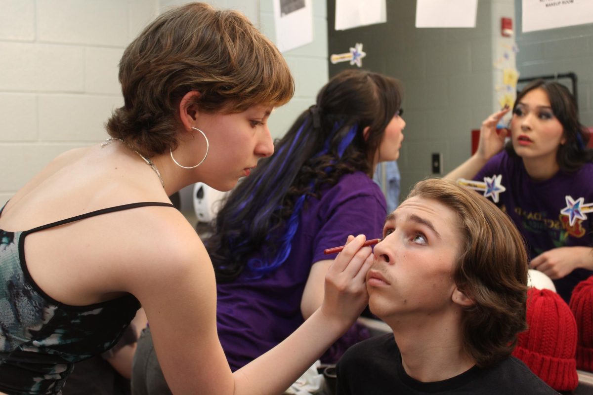 Junior Deli Young applies eyeliner to Max Holtsberry's face. Max played the role of Jay, originally played by Booboo Stewart in the Disney Channel Original Movie.