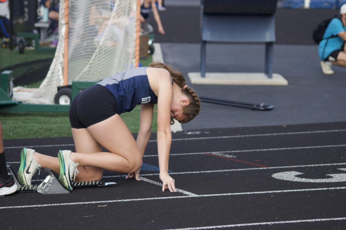Lock in. Audrey Ames (11) waits for the "set" cue before her 400m dash at the dual meet on April 30. Audrey is a strong hurdler and sprinter. 