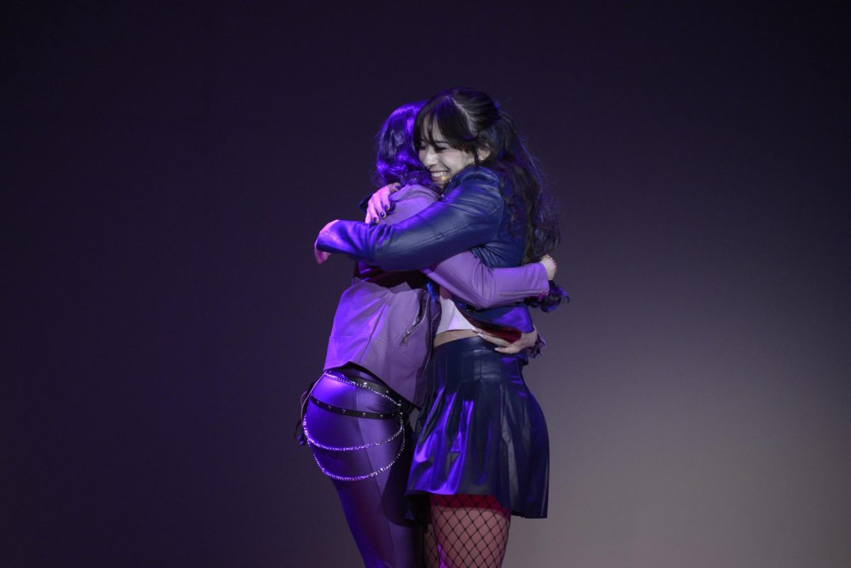 Chloe Thatcher (12), as Mal, and Miho Gillespie (12), as Evie, hug as they part ways after their duet "Space Between."