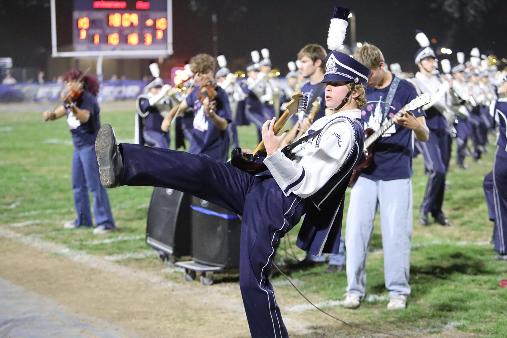 Electric Ensemble member senior Sam Hanning rocks out with his guitar at the Washington Courthouse game Sep. 12.