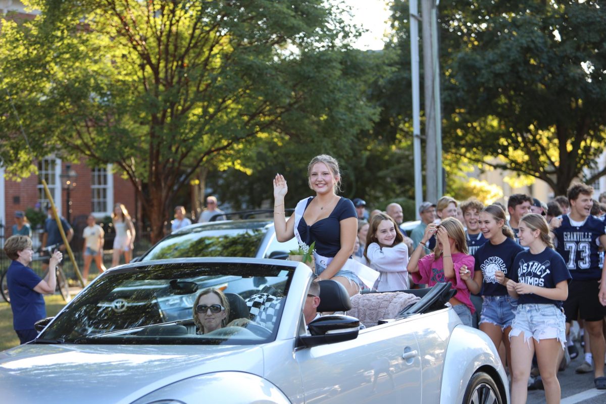 Freshman Emerie Rhodes waves in royalty as the Homecoming court candidate. 