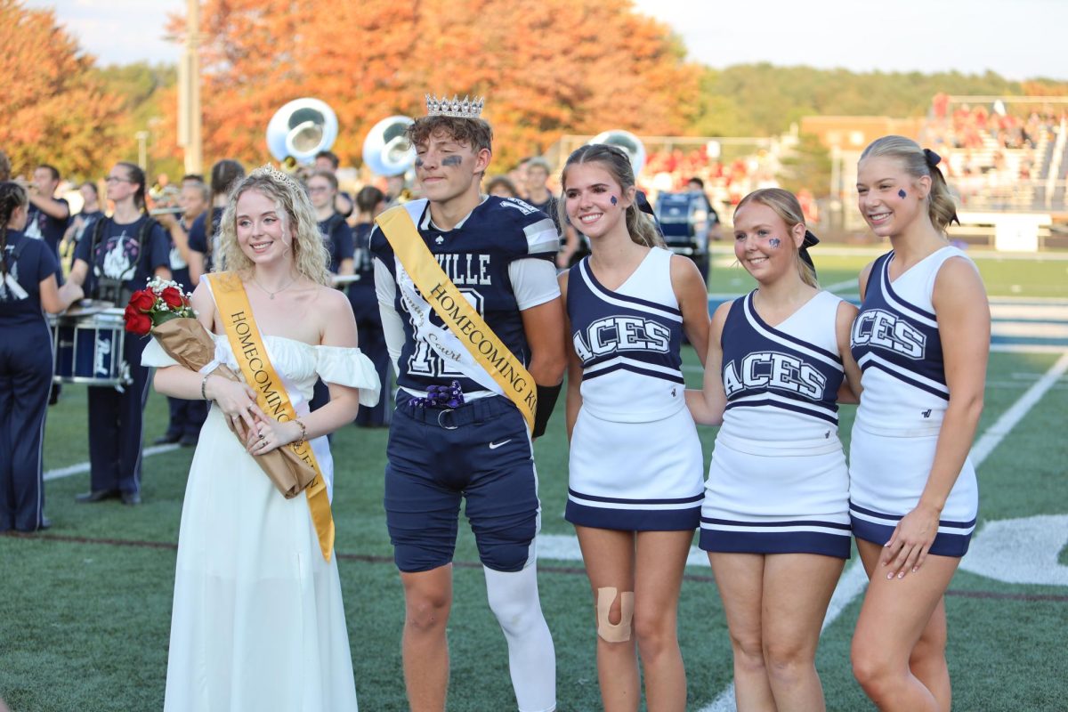 Homecoming Queen Andi Salisbury and King Landon Goss stand on the 50 yard line after being crowned at the Homecoming game.