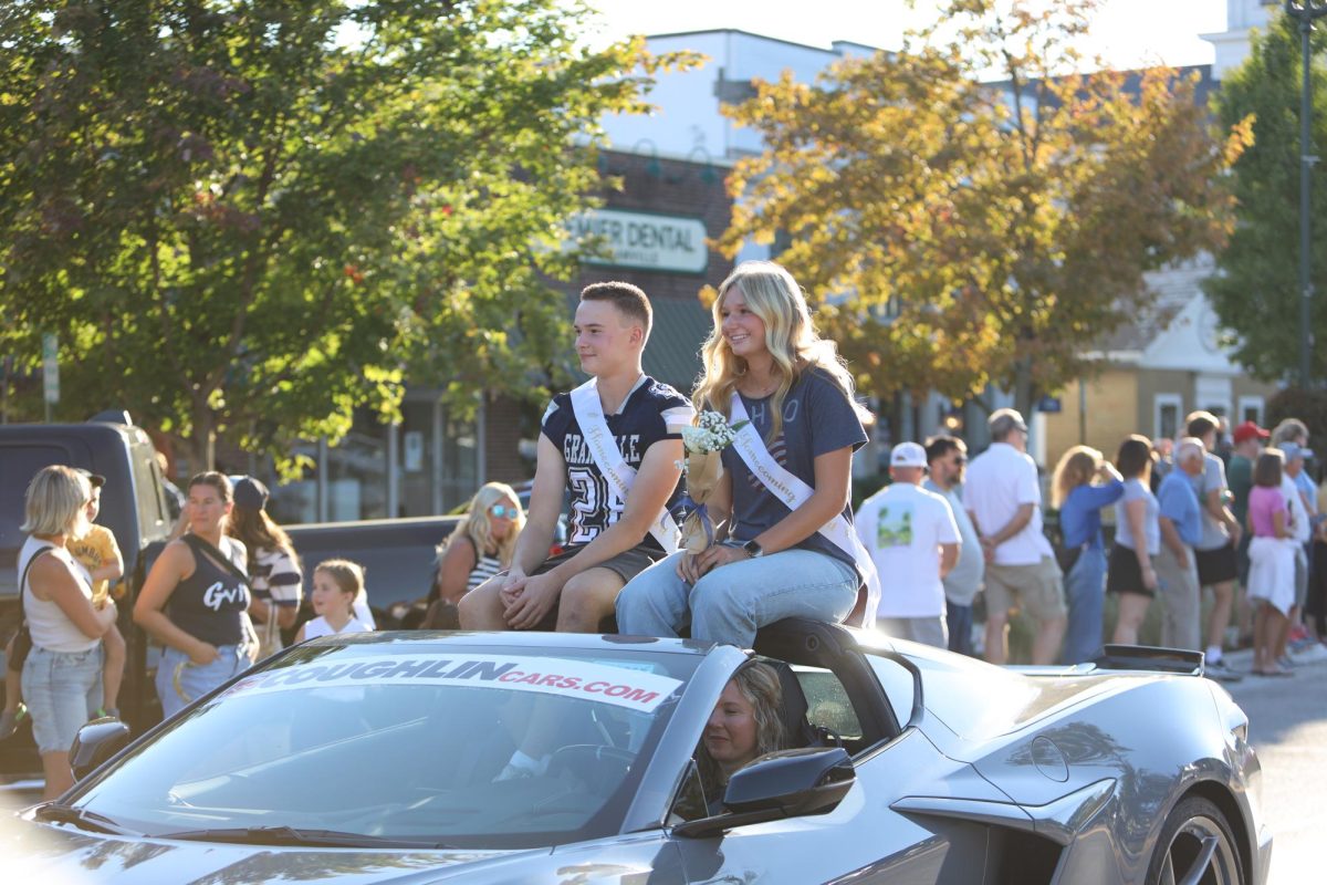Seniors Ava Phillips and Will Bukala ride down Broadway as candidates for Homecoming King and Queen. 
