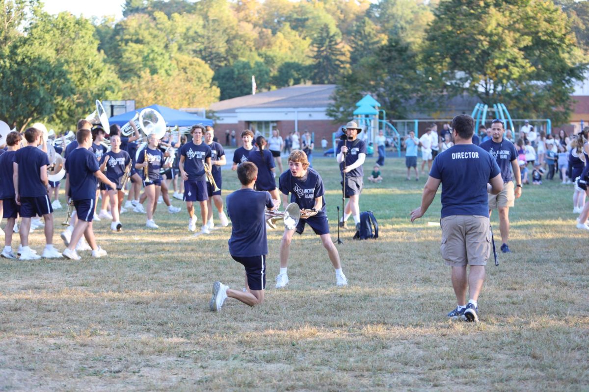 Senior Owen Costa gets down on one knee for fellow senior Sam Hannig during a dance break after the parade. 