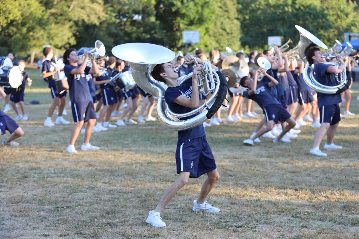Sophomore Ethan Goodman plays the sousaphone and dances to Long Train. 