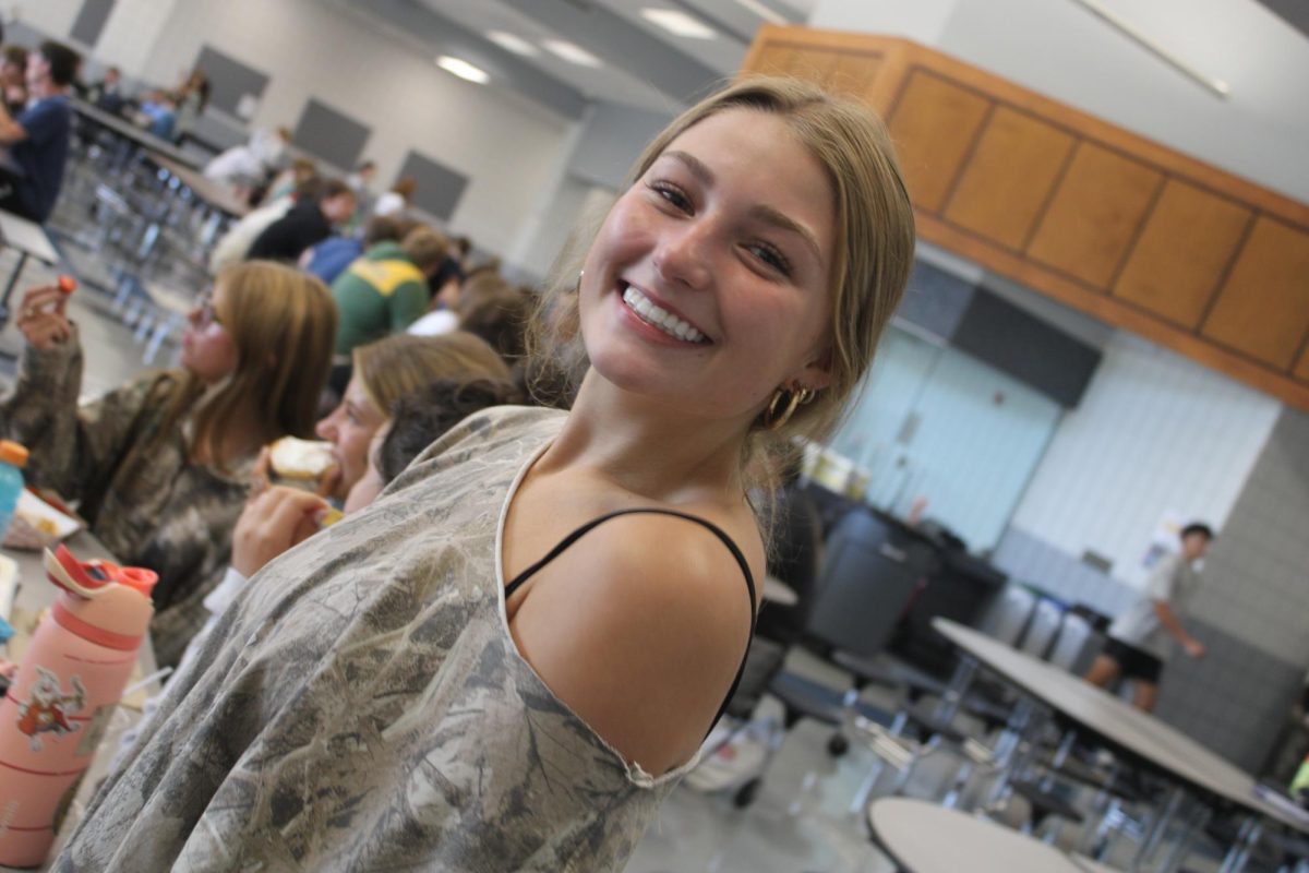 Sophomore Camryn Goss smiles big for Camo Day on September 16.