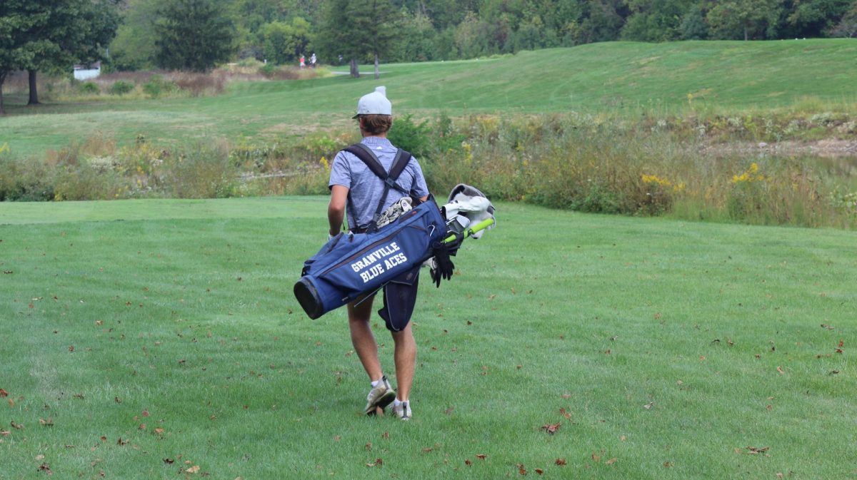 Senior Chase Holtzapple walks to his next hole.