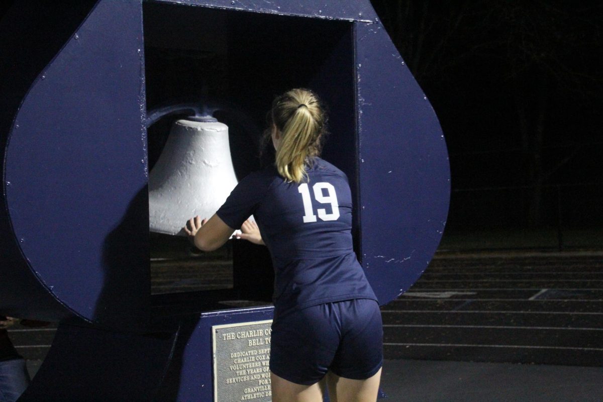Sophomore Maddie Bloomfield rings the bell after defeating Licking Heights. The team was all smiles on that chilly October night. The girls have now made in to the tournament season.