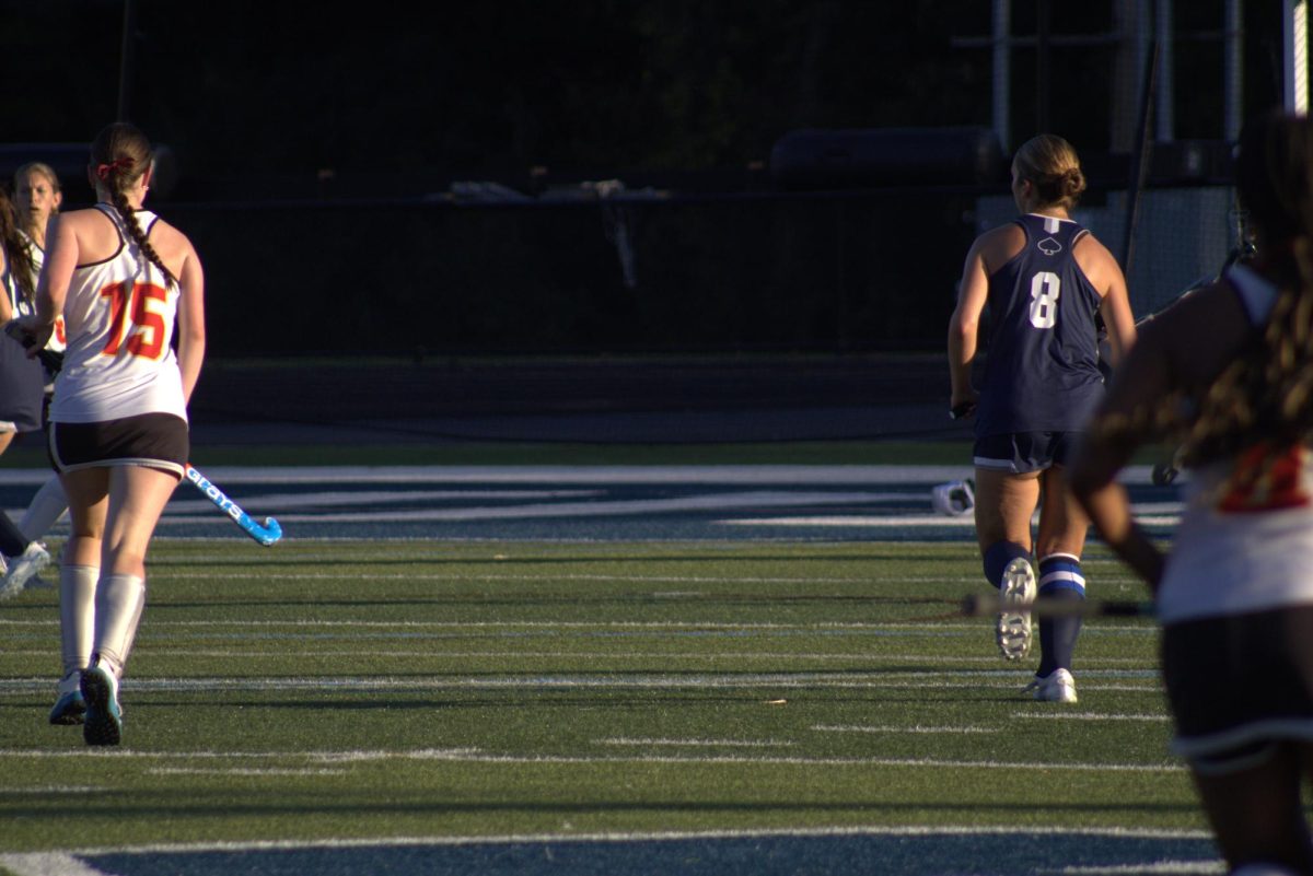 Senior captain Evie Sanders running to win over the ball. Evie Sanders is a fierce competitor.