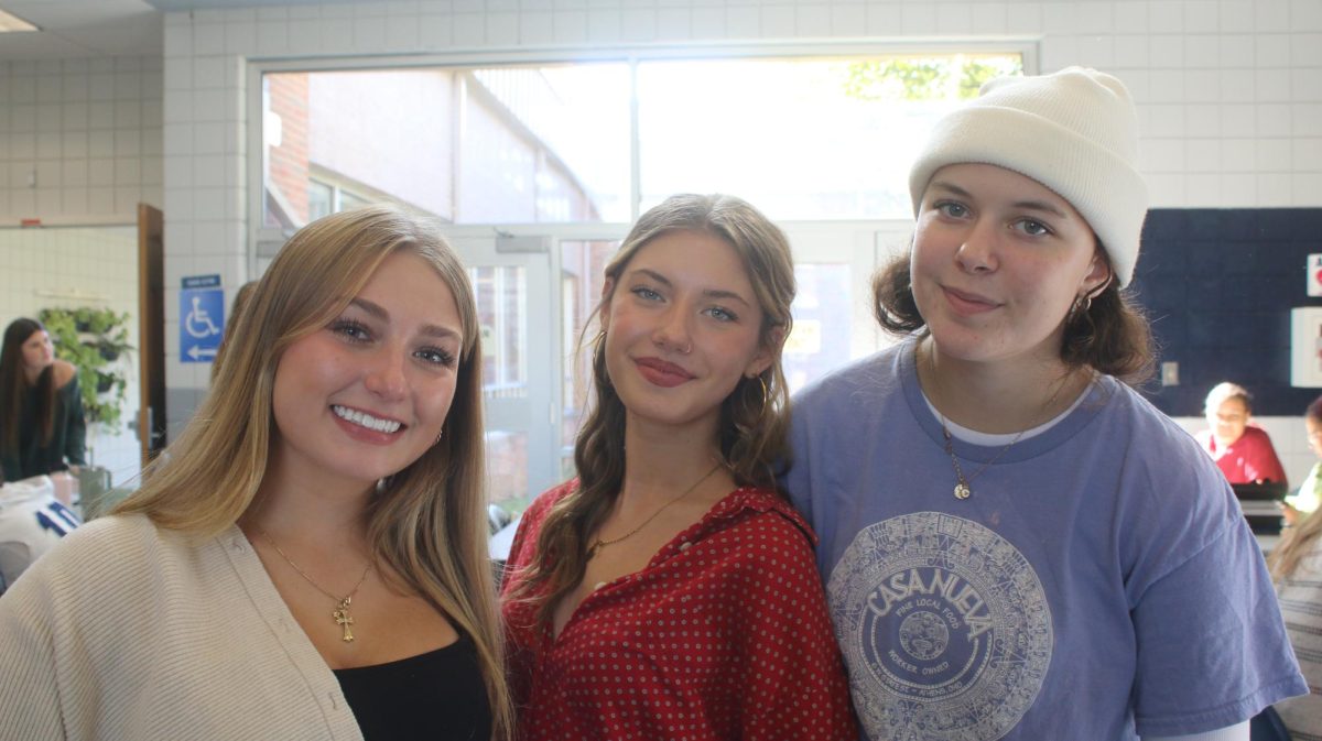 Camryn Goss, Clara Dandurand, Gigi Stone  smile while they wait in line for lunch.