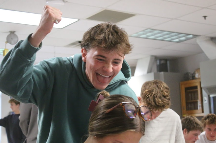 Senior, Keegan Cross poses behind senior, Emma Gulledge