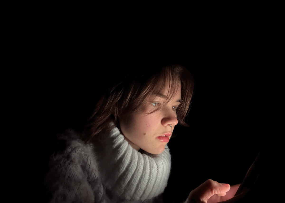 A student scrolls on her phone, not knowing the future consequences