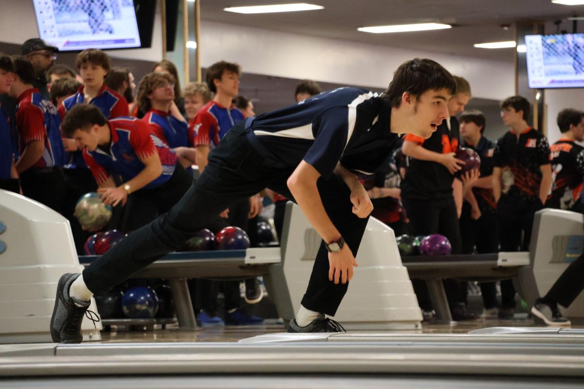 Liam Gadrow (10) finishes strong as he watches his ball barrell towards the pins. Ethan contributed to the team's total score of 1,906.