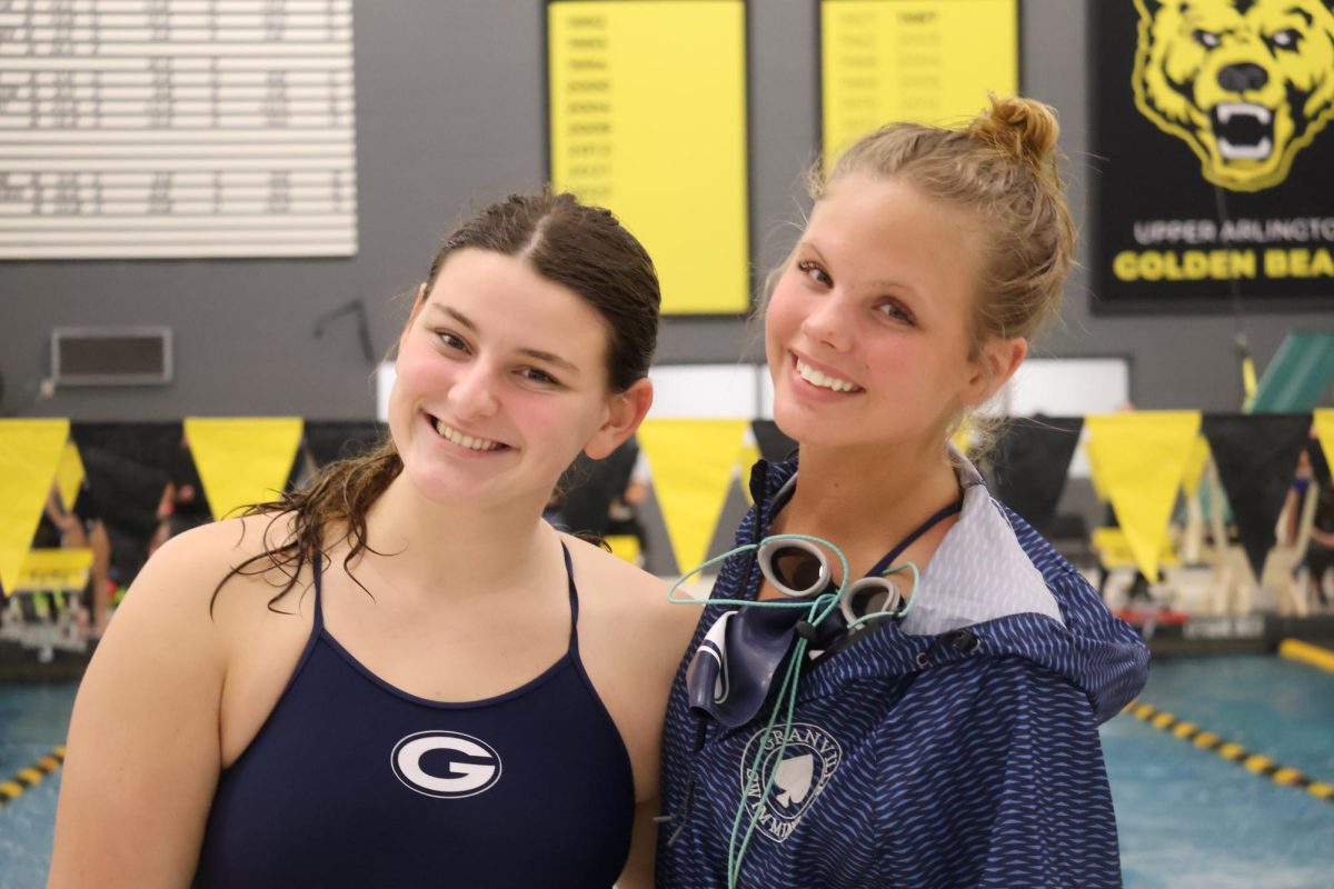 Audrey Wurm and Eliana White pose for a picture together at the Jan. 9 swim meet at Upper Arlington. They have had a lot of fun this season. 